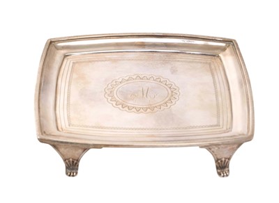 Lot 229 - George III silver teapot stand of rectangular form, with bright cut engraved decoration and central engraved initial 'M', raised on four, scroll feet (London 1806)