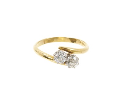 Lot 593 - Diamond two stone crossover ring