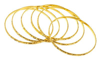 Lot 462 - Six yellow metal bangles, from Guyana, stamped 22K