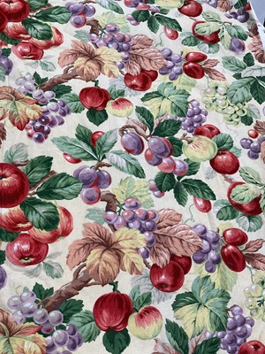 Lot 2131 - Pair of curtains printed brightly coloured fruits on pale yellow ground. Linen and interlined. Measures 85cms across heading, drop 190cms, both approximate.