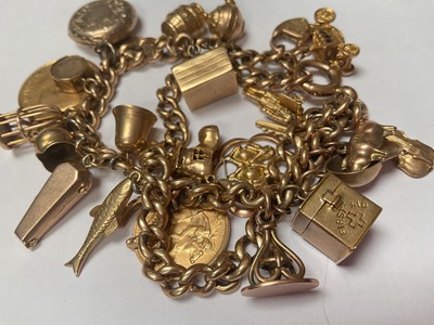 Lot 19 - 9ct gold double row curb link charm bracelet with various 9ct gold and yellow metal charms including a George V gold full sovereign, 1913 and George V gold half sovereign 1912