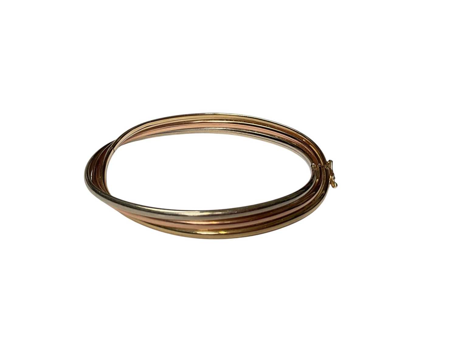 Lot 24 - 9ct three colour gold triple row twisted bangle