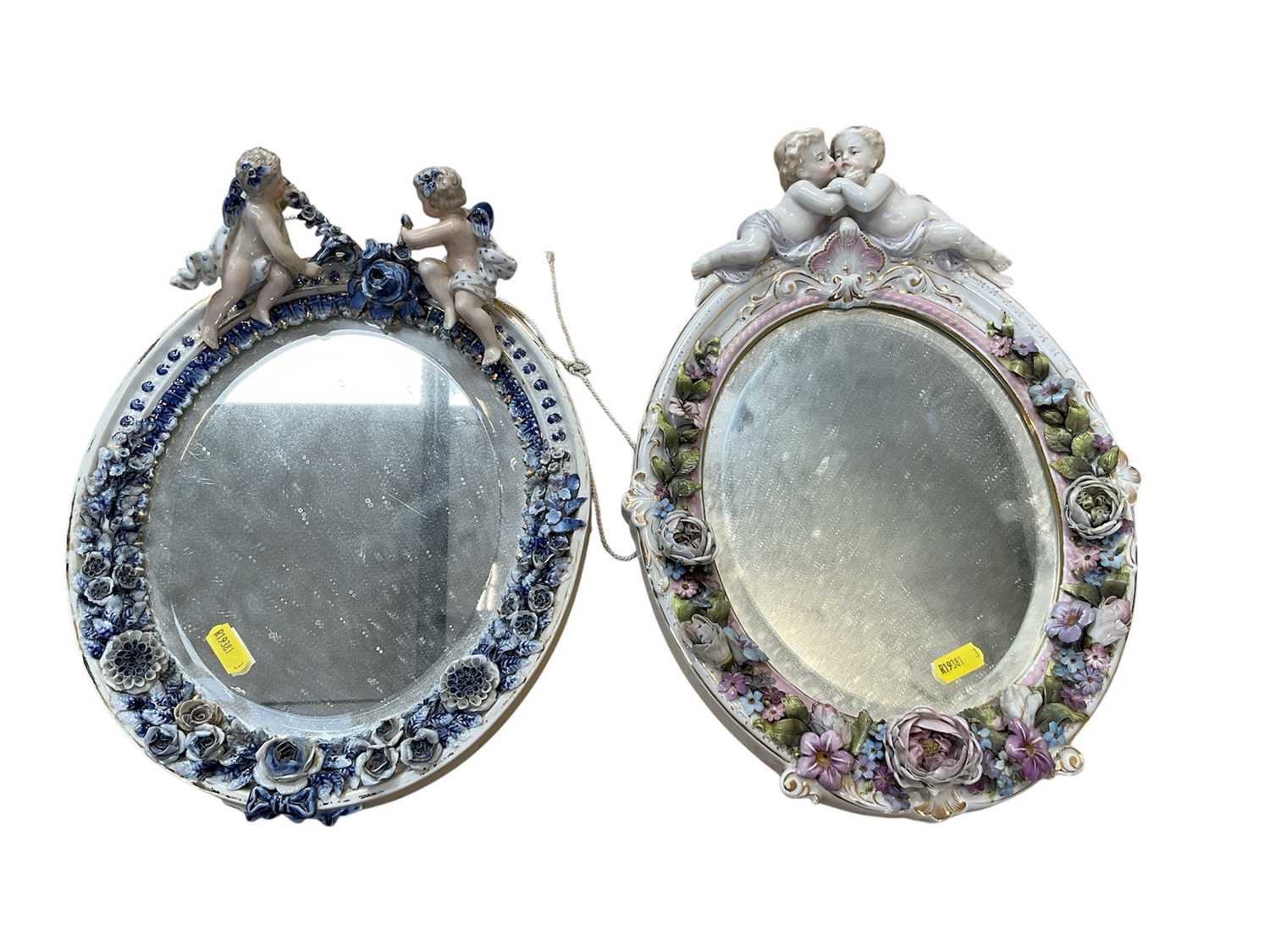 Lot 5071 - Two Continental porcelain dressing table mirrors with figural decoration, (2).
