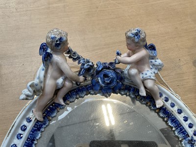Lot 5071 - Two Continental porcelain dressing table mirrors with figural decoration, (2).