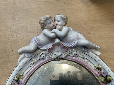 Lot 5071 - Two Continental porcelain dressing table mirrors with figural decoration, (2).