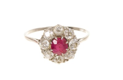 Lot 431 - Ruby and diamond cluster ring with central ruby surrounded by eight old cut diamonds in claw setting in platinum shank, circa 1920