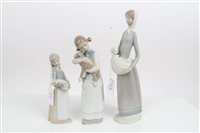 Lot 2136 - Two Lladro porcelain figures - girl holding...
