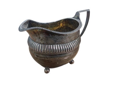 Lot 310 - Georgian silver milk jug with gadrooned edge, engraved floral border, on four ball feet, (London 1814), 10.6cm high, 5.5oz.