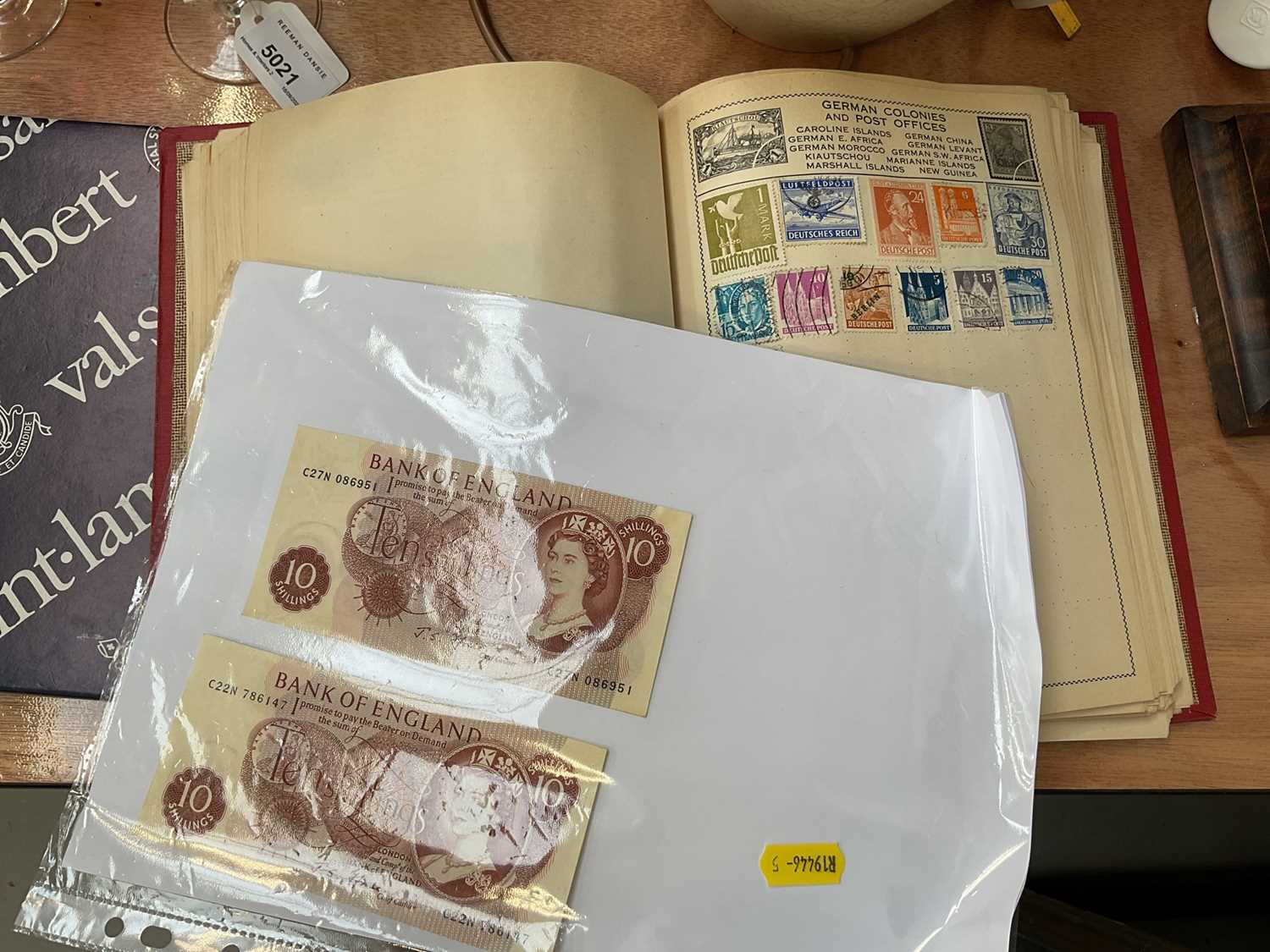 Lot 5024 - Stamp album together with two 10 shillings bank notes.
