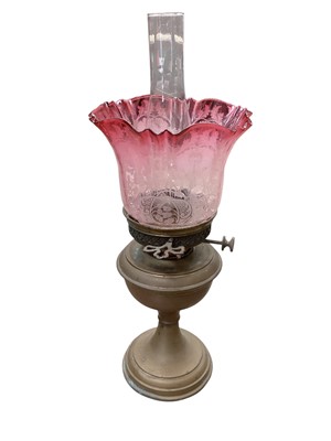 Lot 5092 - Three brass oil lamps, together with six oil lamp chimneys and four glass shades including a cranberry and a green glass example.