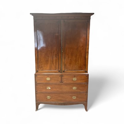 Lot 1272 - Early 19th century mahogany and ebony line inlaid linen press, with stepped cornice and with interior of slides enclosed by a pair of panelled doors, two short over two long drawers below