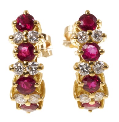 Lot 405 - Pair of ruby and diamond earrings with pairs of brilliant cut diamonds interspaced by round mixed cut rubies in claw setting with post and butterfly fittings