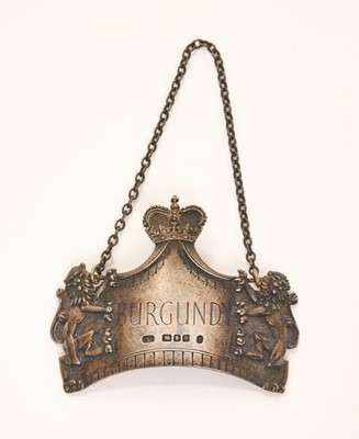 Lot 202 - Leslie Gordon Durbin (1913 - 2005), contemporary silver wine / decanter label with engraved naming 'Burgundy', flanked by two lions below a central crown, (London 1952), maker Leslie Gordon Durb...