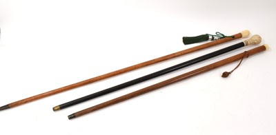 Lot 811 - Victorian ebonised stick with ornately carved ivory handle and two further ivory mounted 19th century canes