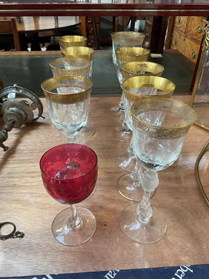 Lot 5021 - Nine Bohemian gilt and cut wine glasses with baluster stems, and a cranberry glass