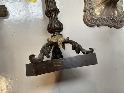 Lot 5028 - Regency bronze candlestick, with column stem and scroll feet on a shaped base, together with a gilt candlestick converted to a lamp and a silver plated candlestick (3)
