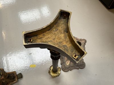 Lot 5028 - Regency bronze candlestick, with column stem and scroll feet on a shaped base, together with a gilt candlestick converted to a lamp and a silver plated candlestick (3)