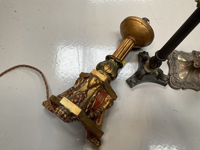 Lot 5028 - Regency bronze candlestick, with column stem and scroll feet on a shaped base, together with a gilt candlestick converted to a lamp and a silver plated candlestick (3)