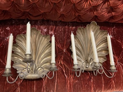 Lot 1504 - Pair of antique brass wall sconces with shell-shaped backs and three scroll candle arms