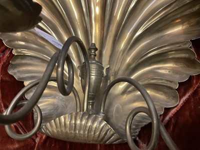 Lot 1504 - Pair of antique brass wall sconces with shell-shaped backs and three scroll candle arms
