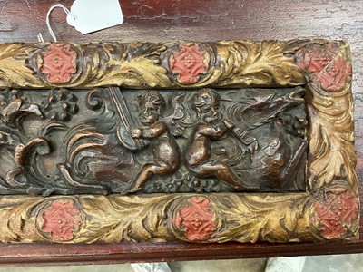Lot 1510 - Antique, probably 17th century, carved oak frieze, depicting putto and mythical creatures, presented in a gilt and painted moulded frame, 15.5cm x 47.5cm