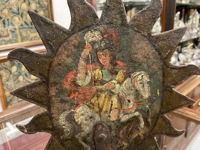 Lot 1513 - 19th century, or earlier, painted metal double-sided table screen depicting figures within a sunburst, on circular base