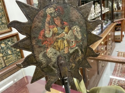 Lot 1513 - 19th century, or earlier, painted metal double-sided table screen depicting figures within a sunburst, on circular base