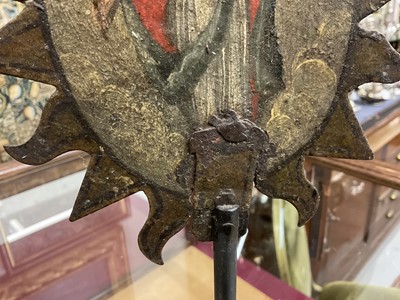 Lot 1513 - 19th century, or earlier, painted metal double-sided table screen depicting figures within a sunburst, on circular base