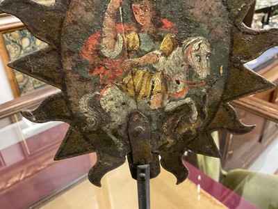 Lot 1513 - 19th century, or earlier, painted metal double-sided table screen depicting figures within a sunburst, on circular base