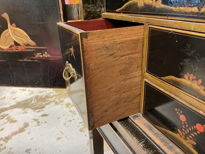 Lot 1522 - Late 17th / early 18th century Chinese lacquer cabinet on stand, the twin hinged doors decorated with landscapes, brass strap hinges, enclosing an arrangment of drawers, on square legs
