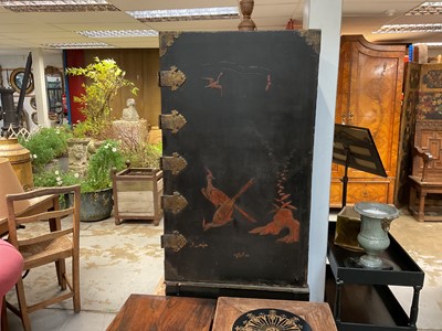 Lot 1522 - Late 17th / early 18th century Chinese lacquer cabinet on stand, the twin hinged doors decorated with landscapes, brass strap hinges, enclosing an arrangment of drawers, on square legs