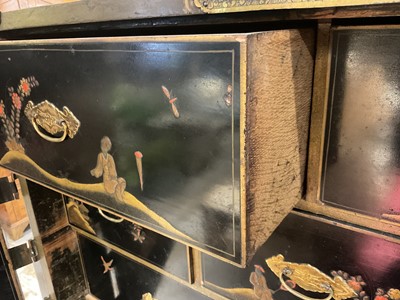 Lot 1522 - Late 17th / early 18th century Chinese lacquer cabinet on stand, the twin hinged doors decorated with landscapes, brass strap hinges, enclosing an arrangment of drawers, on square legs