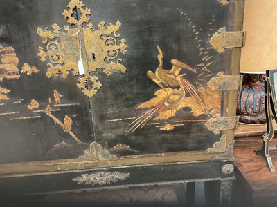 Lot 1522 - Late 17th / early 18th century Chinese lacquer cabinet on stand, the twin hinged doors decorated with landscapes, brass strap hinges, enclosing an arrangment of drawers, on square legs