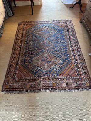 Lot 1775 - Antique Persian rug with geometric panels, on red and blue ground