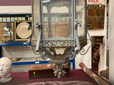 Lot 1925 - Antique wrought iron and painted garden lantern of hexagonal form with elaborate acanthus leaf ornament and glazed sides, 120cm high. Provenance: believed to have been removed from a Roth...