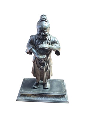 Lot 5008 - Antique Japanese metal figure of a man with a serpent on his back, standing on a rectangular plinth base