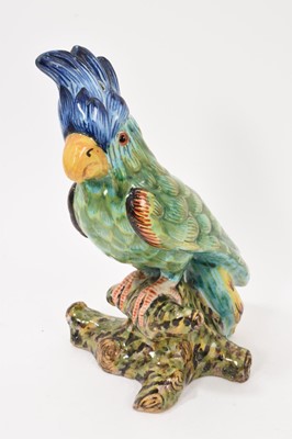 Lot 243 - Late 19th century French faience pottery cockatoo, with glass eyes. Painted mark to base. 25cm high