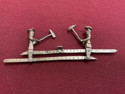 Lot 852 - Dutch silver mechanical toy, of two woodcutters, 11cm wide, Amsterdam mark