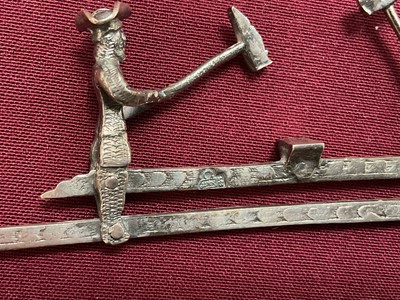 Lot 852 - Dutch silver mechanical toy, of two woodcutters, 11cm wide, Amsterdam mark