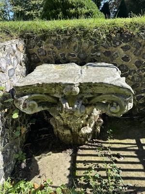 Lot 1930 - Pair of 18th century English carved stone classical capitals with scrolling mounts, later applied lead tops, 52cm high overall