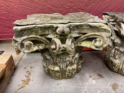 Lot 1930 - Pair of 18th century English carved stone classical capitals with scrolling mounts, later applied lead tops, 52cm high overall