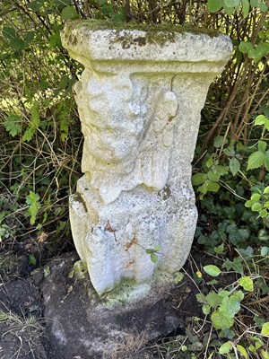 Lot 1935 - Pair of 17th / 18th century carved stone mounts, each with winged cherubic figures, approximately 70cm high, set into a concrete base
