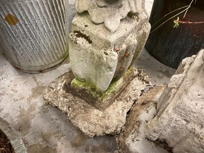 Lot 1935 - Pair of 17th / 18th century carved stone mounts, each with winged cherubic figures, approximately 70cm high, set into a concrete base