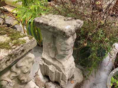Lot 1935 - Pair of 17th / 18th century carved stone mounts, each with winged cherubic figures, approximately 70cm high, set into a concrete base