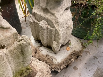 Lot 1935 - Pair of 17th / 18th century carved stone mounts, each with winged cherubic figures, approximately 70cm high, set into a concrete base