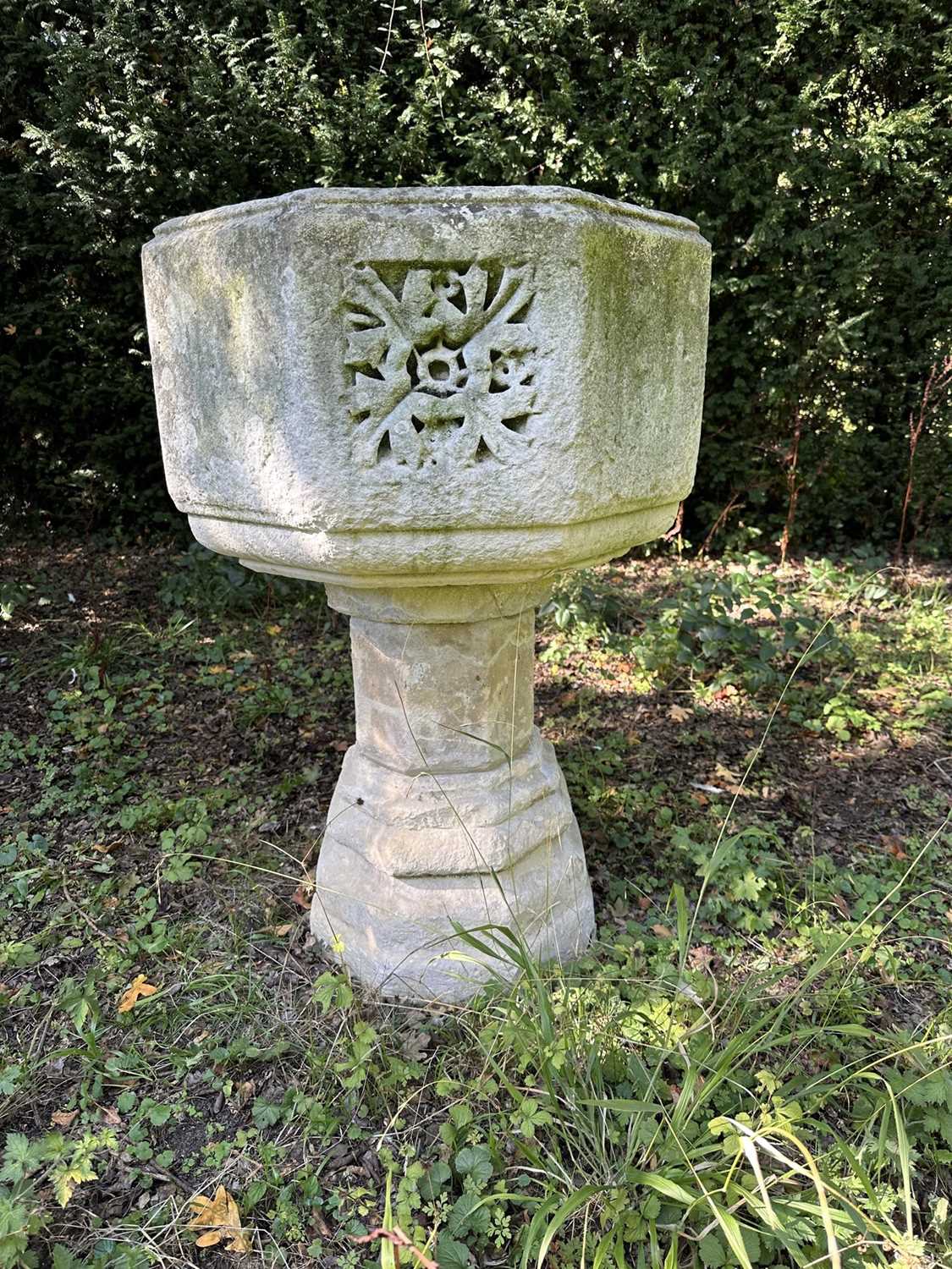 Lot 1940 - Good antique carved stone font of octagonal form with four leaf carved panels, on octagonal columns and stepped base, 67cm wide x 100cm high