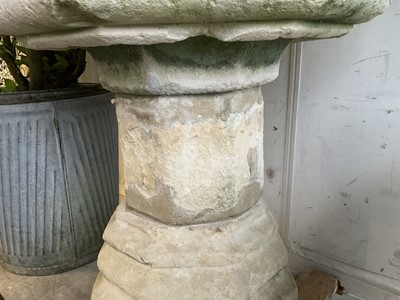 Lot 1940 - Good antique carved stone font of octagonal form with four leaf carved panels, on octagonal columns and stepped base, 67cm wide x 100cm high