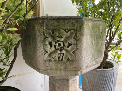 Lot 1940 - Good antique carved stone font of octagonal form with four leaf carved panels, on octagonal columns and stepped base, 67cm wide x 100cm high