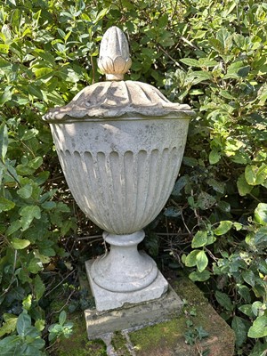 Lot 1941 - Antique Coade stone urn, the foliate knop above a domed cover and fluted body, circular socle and square base, approximately 60cm high
