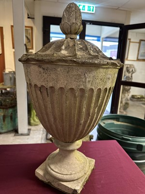 Lot 1941 - Antique Coade stone urn, the foliate knop above a domed cover and fluted body, circular socle and square base, approximately 60cm high